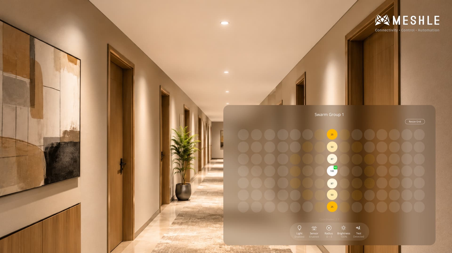 Long corridor with luminaires brightening ahead of a walking person and dimming behind, illustrating MESHLE Swarm corridor function.