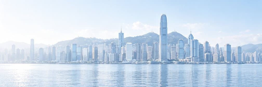 Hong Kong skyline across Victoria Harbour on a bright, clear day