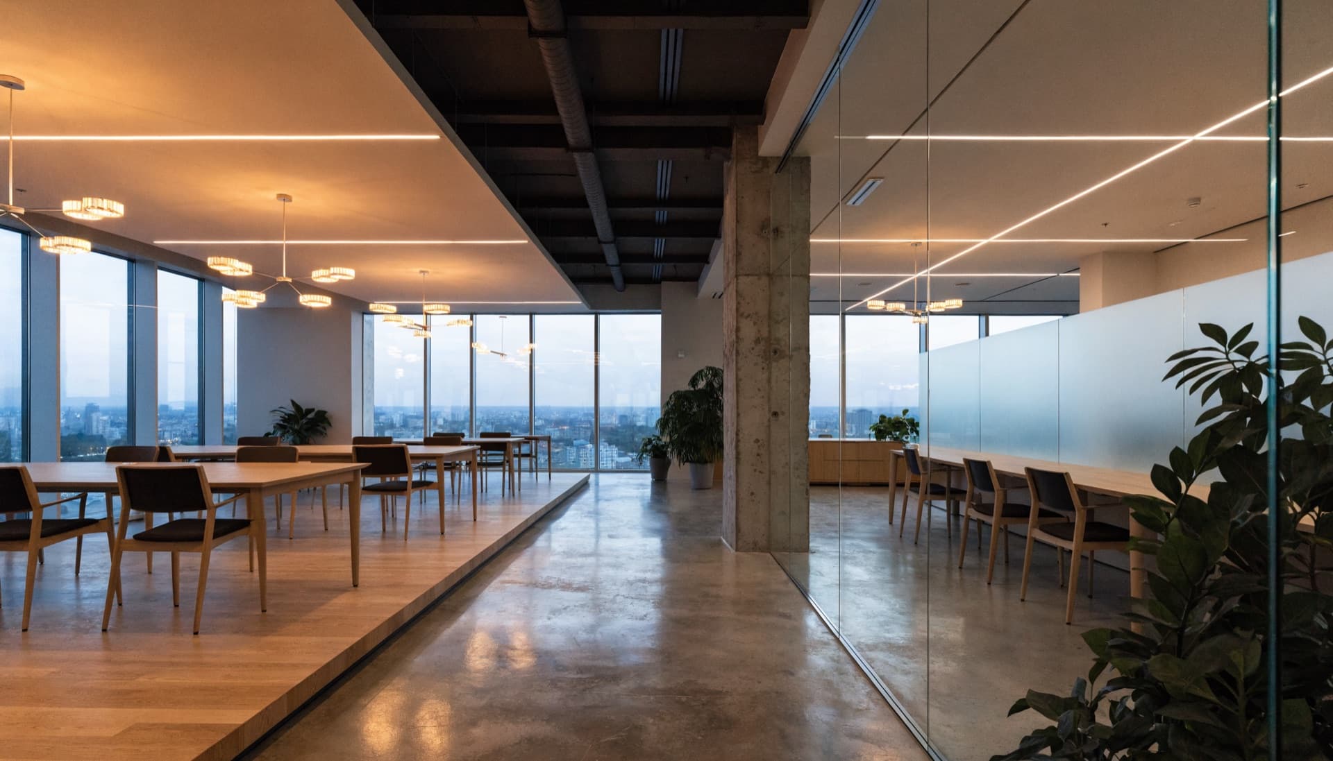 Modern open-plan office at dusk with tunable LED lighting